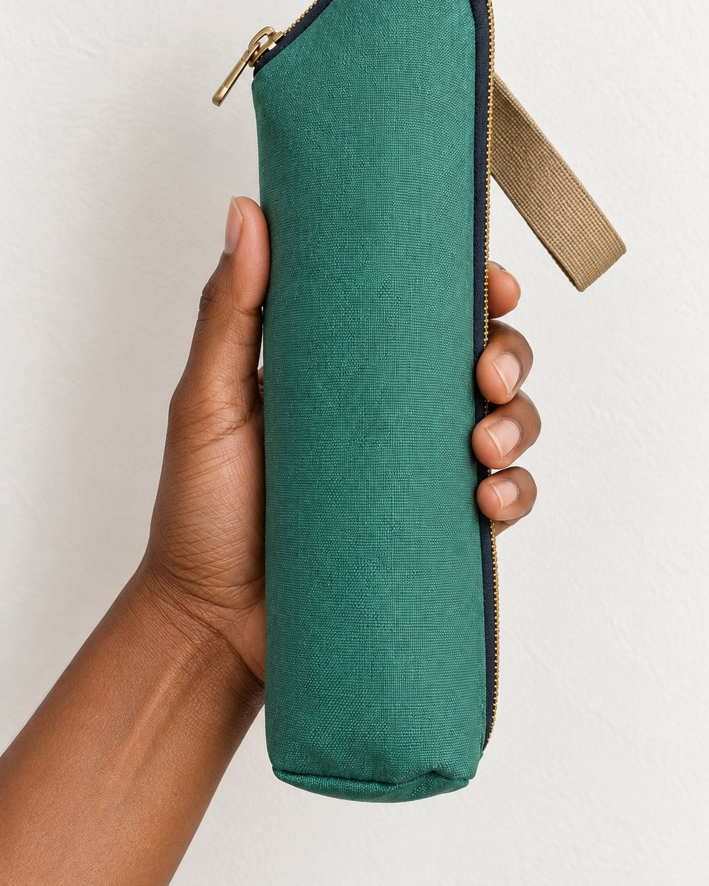 Bottle bag held in one hand, about as long as a forearm from wrist to elbow