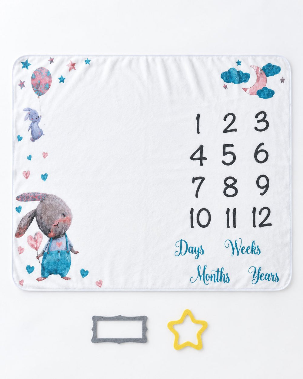 Blanket laid flat with the yellow felt star and grey felt frame placed beside it