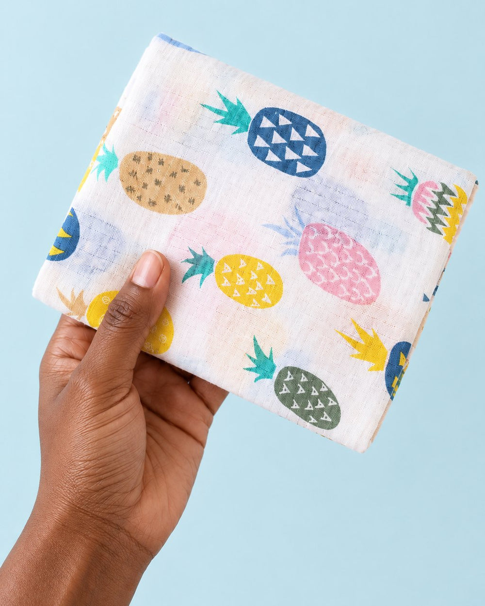 Muslin folded into a small square in one hand