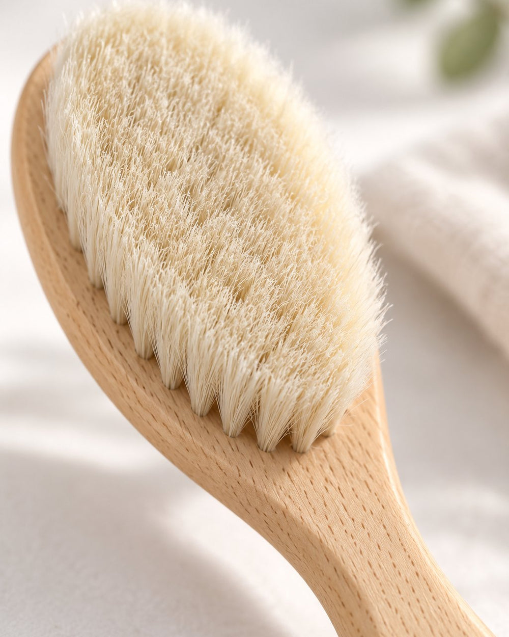 Close-up of the soft cream goat-hair bristles and beech handle