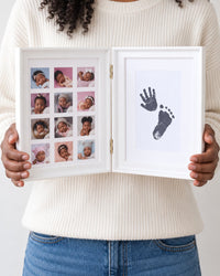 Adult holding the open frame in both hands, showing its size