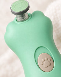 Close-up of the nail file's small round grinding pad and paw-print power button