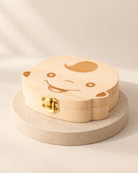 Light wooden tooth box shaped like a smiling boy's face with swept hair