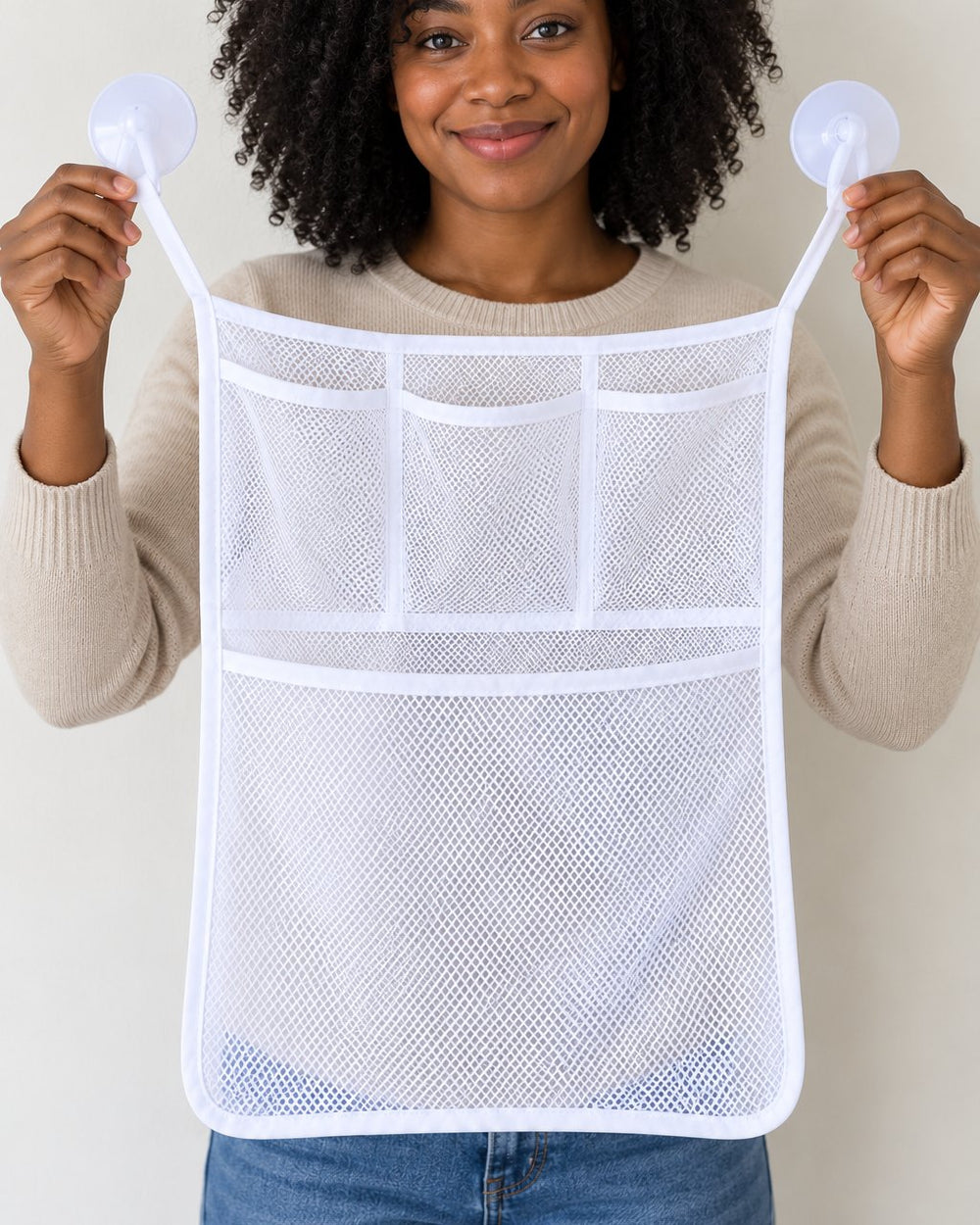 Empty mesh net held up by an adult, about the width of a bath towel folded in half