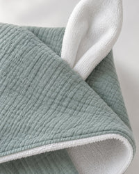 Close-up of the crinkly sage gauze, the white towelling lining and one white bunny ear