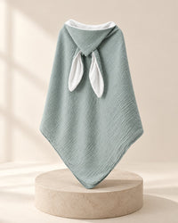 Sage-green muslin hooded towel with two white bunny ears, hood up