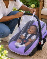 Parent pulling the white mesh net over an infant carrier on a garden patio