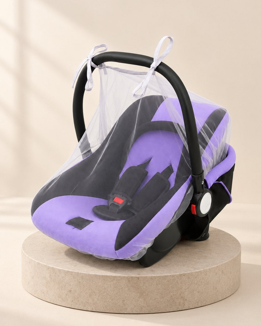 Infant car seat covered by a white mesh net gathered snugly round its base