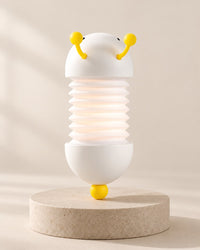 White caterpillar night light with a stretched concertina body, yellow antennae and yellow tail ball