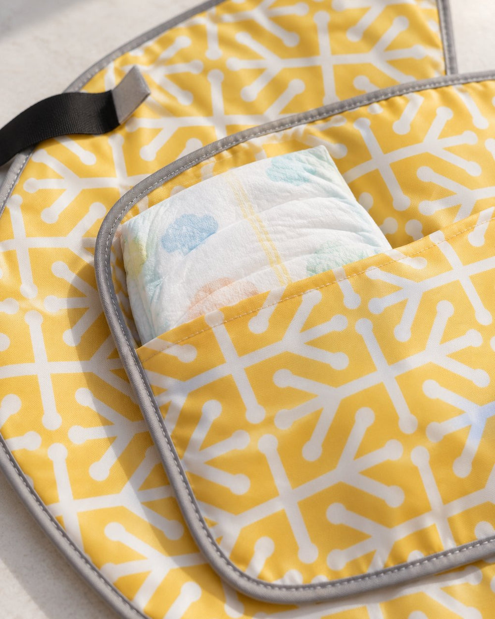 Close-up of the clutch's inside pocket holding a folded diaper