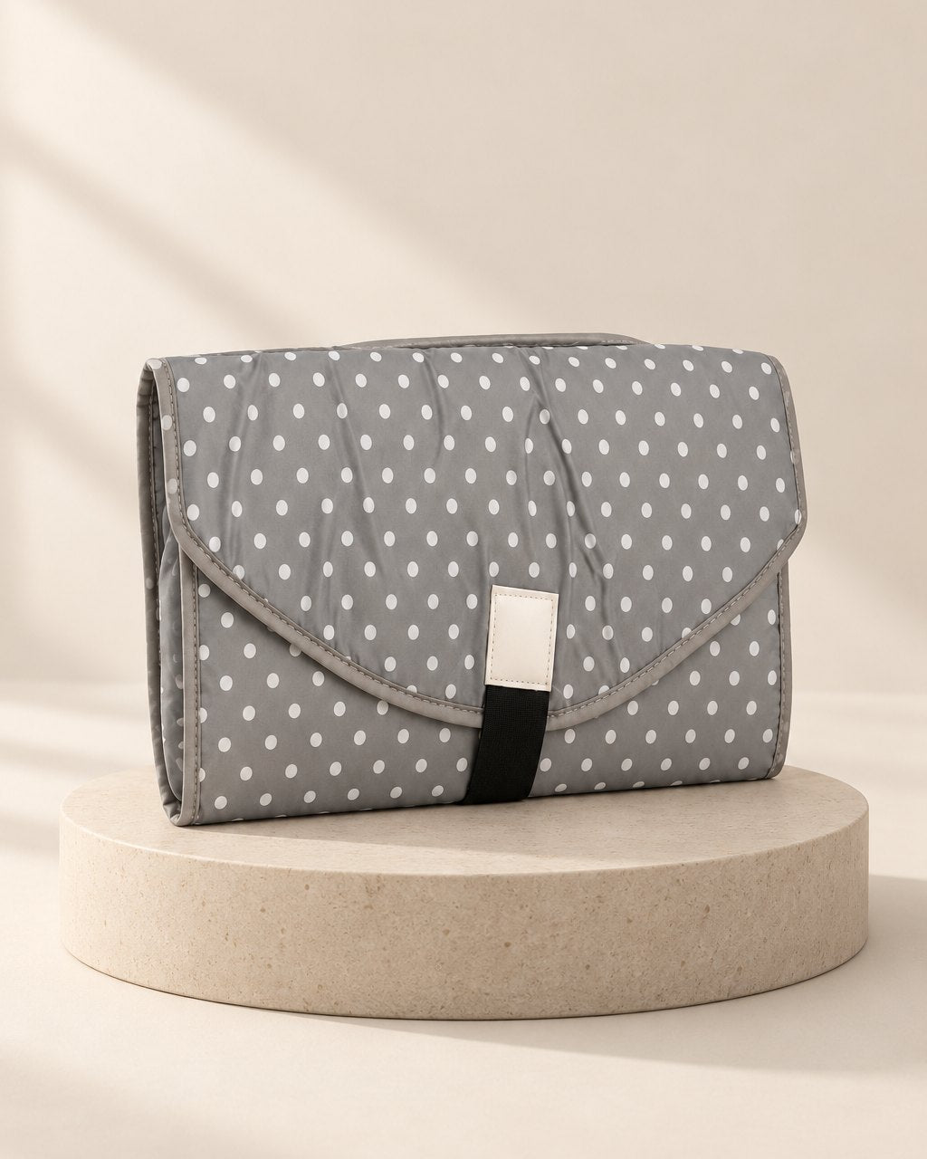 Grey changing clutch with small white polka dots
