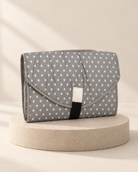 Grey changing clutch with small white polka dots