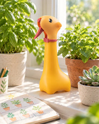 Yellow giraffe mister standing among potted herbs on a sunny sill