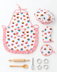 All 11 pieces laid out: apron, cap, mitt, pot holder, rolling pin, spoon, whisk and cutters