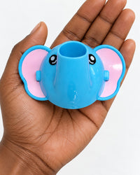 Elephant faucet extender held in an adult palm