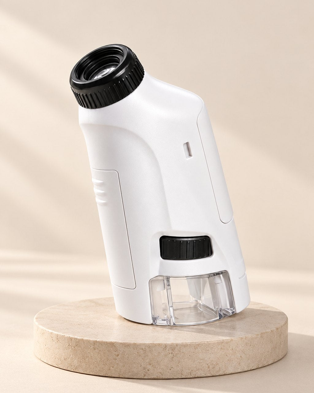 White pocket microscope with a black eyepiece, side zoom wheel and clear base