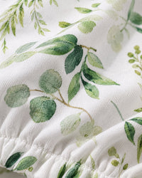 Close-up of the soft stretch fabric and green leaf print at the cover's elastic edge