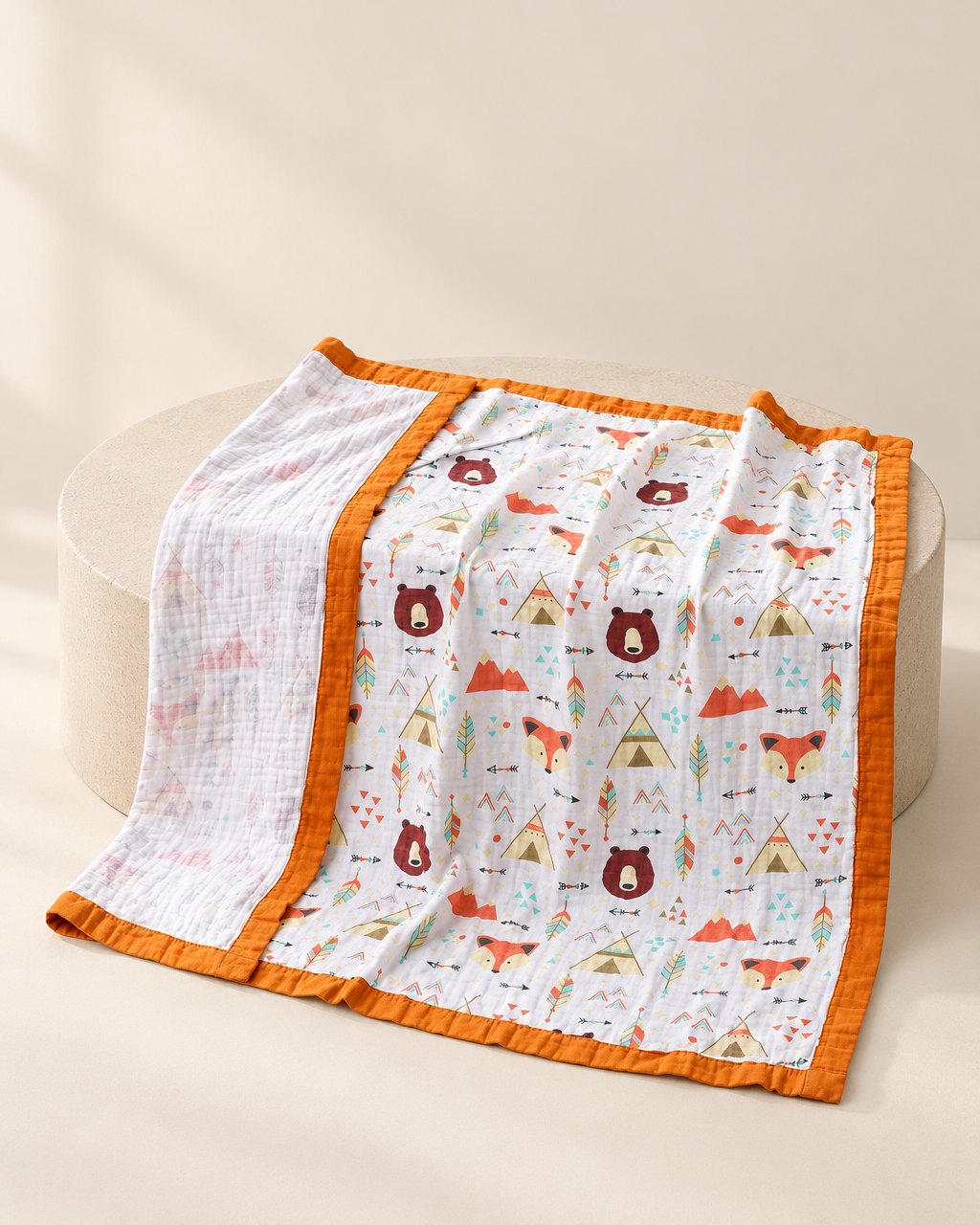 Muslin blanket with a camping bears print and an orange edge