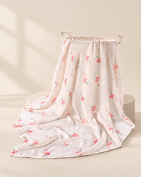 Muslin swaddle blanket with a pink flamingo print