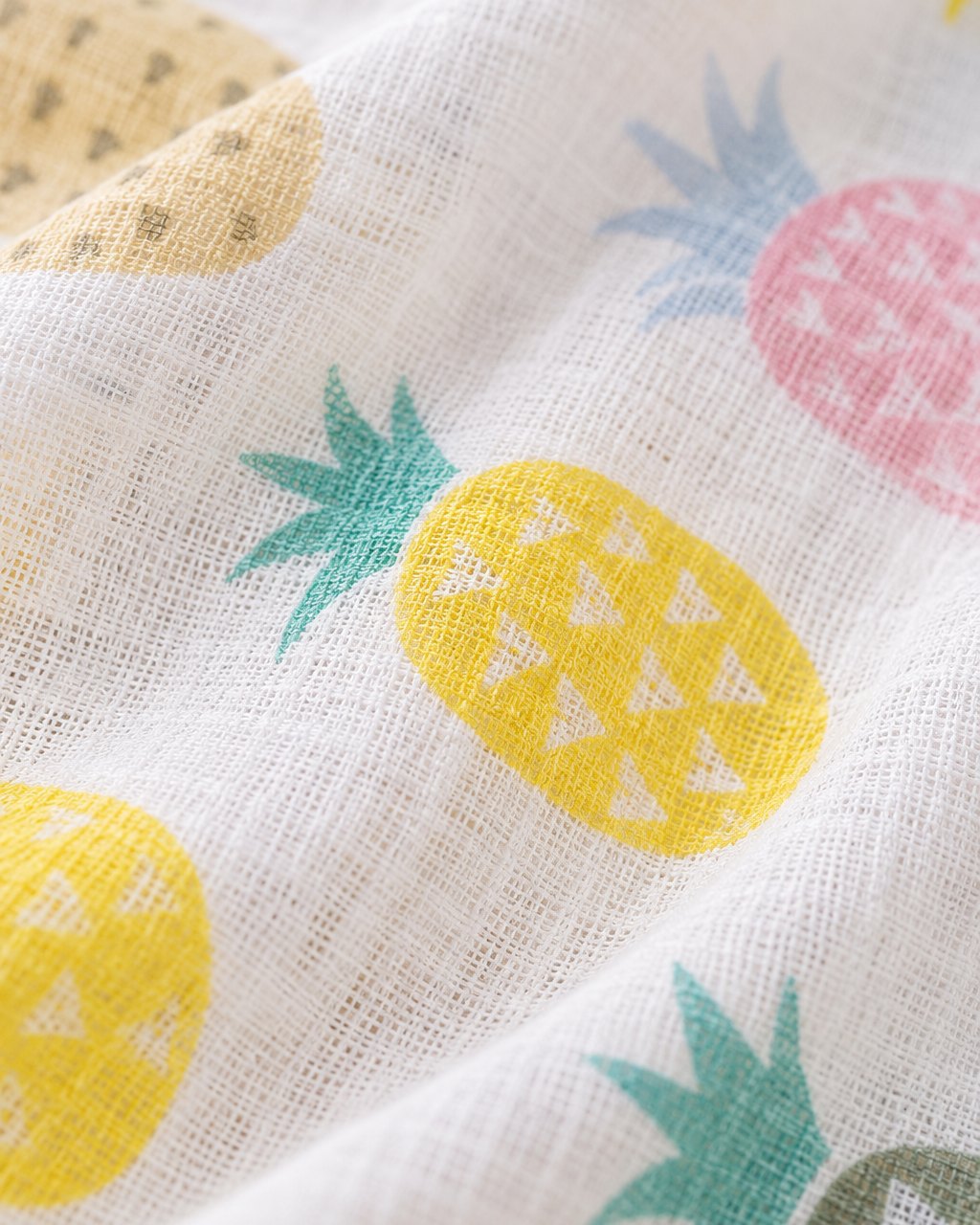 Close-up of the soft crinkled muslin weave and pineapple print