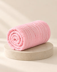 Blush-pink six-layer muslin blanket, folded