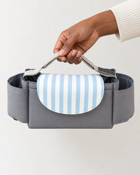 Organizer bag held in one hand, showing its slim 30 cm width
