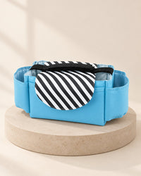 Light blue stroller organizer with a black-and-white striped flap