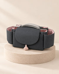 Charcoal stroller organizer with a plain flap and a small pink tassel
