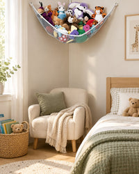 Tidy kids' bedroom with plush toys in a white corner net above a reading chair