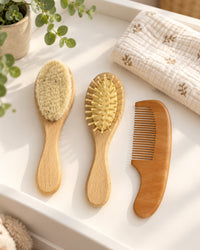 Wooden brush set on a changing table beside a folded towel