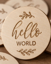 Close-up of the 'hello world' disc with its soft script and wood grain