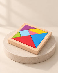 Seven bright wooden tangram pieces fitted together in a square pine tray